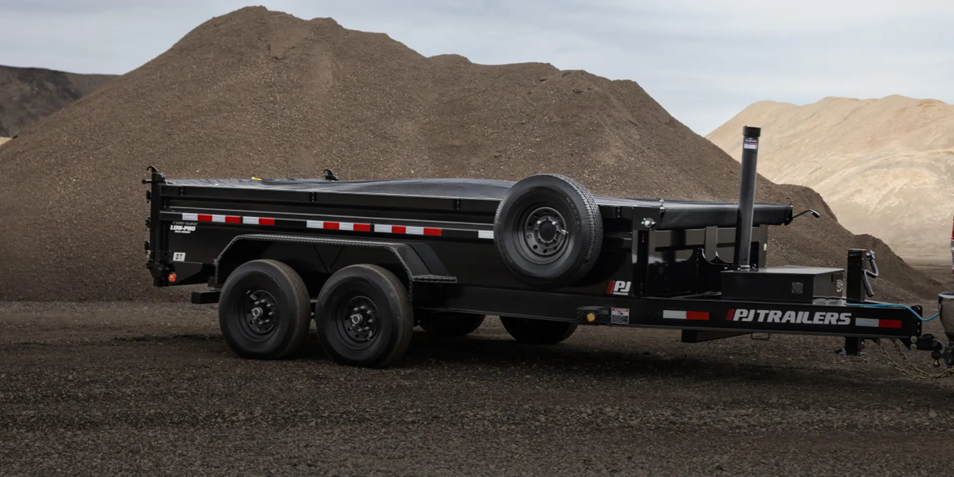 The 83" Pro-Lift Dump Trailer inside an aggregate material site