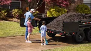 Family loading mulch into their 72