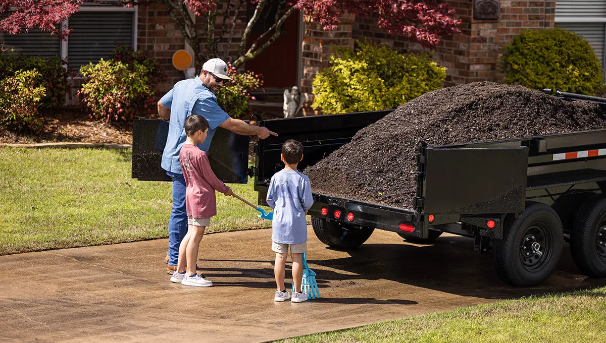 Family loading mulch into their 72