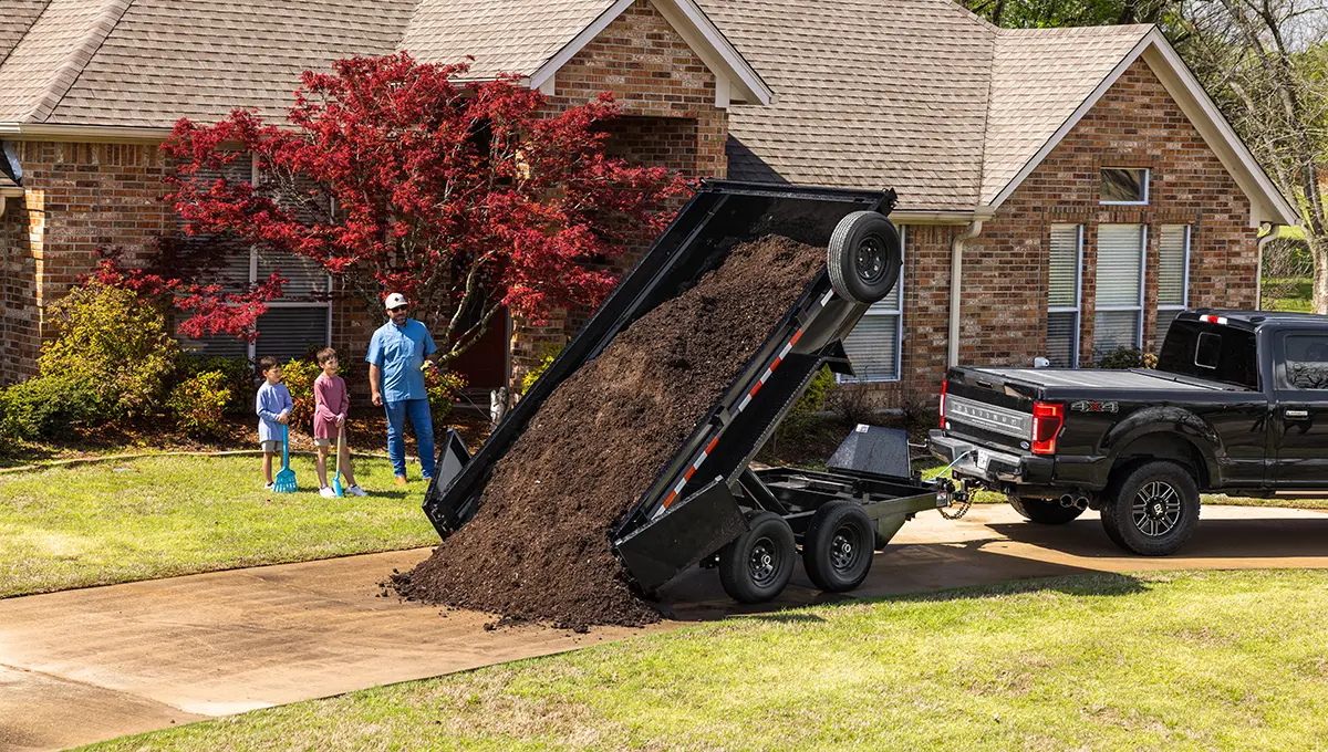 Family dumping mulch from their 72