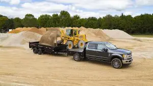 Front loader dumping dirt into the 83