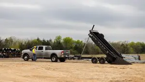 Worker dumping mulch from the 83