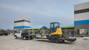 The Voyager Seamless I-Beam Equipment Trailer (EV) hauling a John Deere crawler dozer