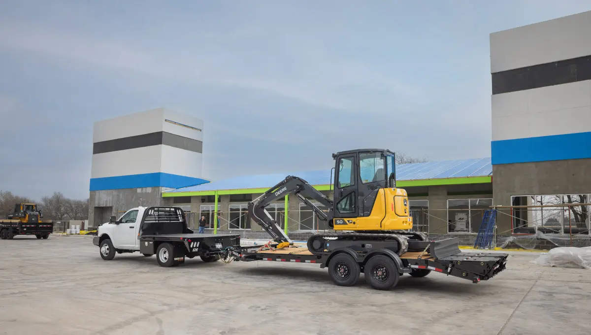 The Voyager Seamless I-Beam Equipment Trailer (EV) hauling a John Deere crawler dozer