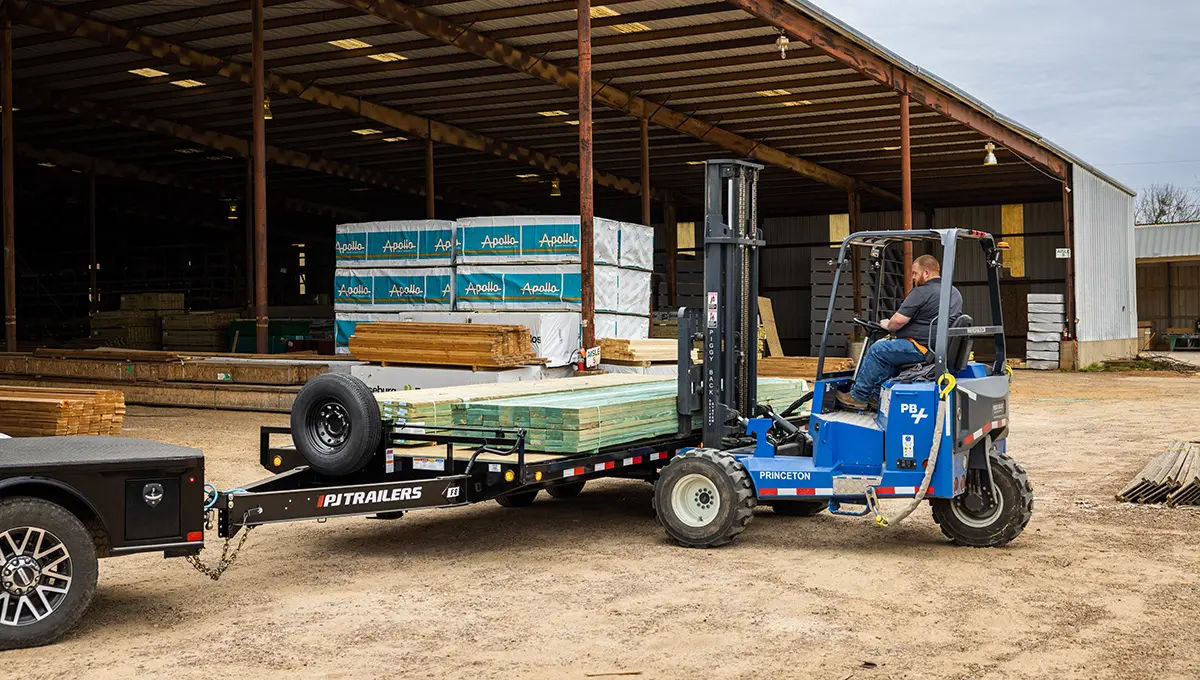 Worker loading lumber onto the 8