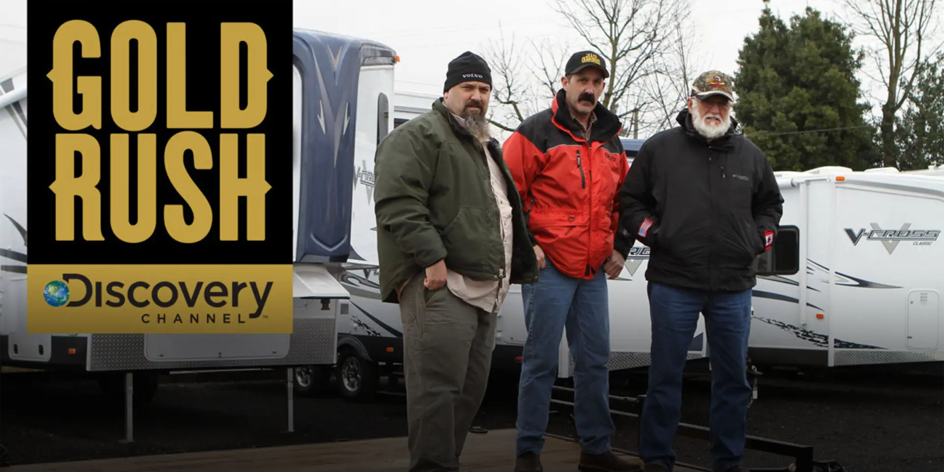 Three stars of the Gold Rush TV show standing on a trailer from PJ Trailers