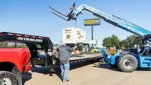 Loading a heavy power generator onto the Low-Pro Flatdeck Trailer With Duals