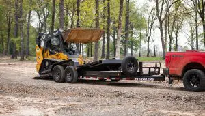 Loading a John Deere skid loader onto the HD Equipment Tilt 6