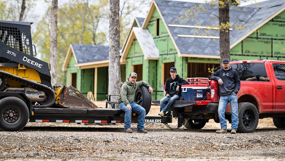 Three workers posing for a picture with the HD Equipment Tilt 6