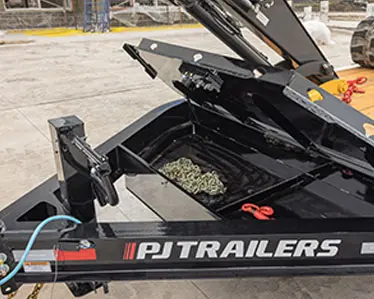 A utility trailer's toolbox holding chains and other equipment